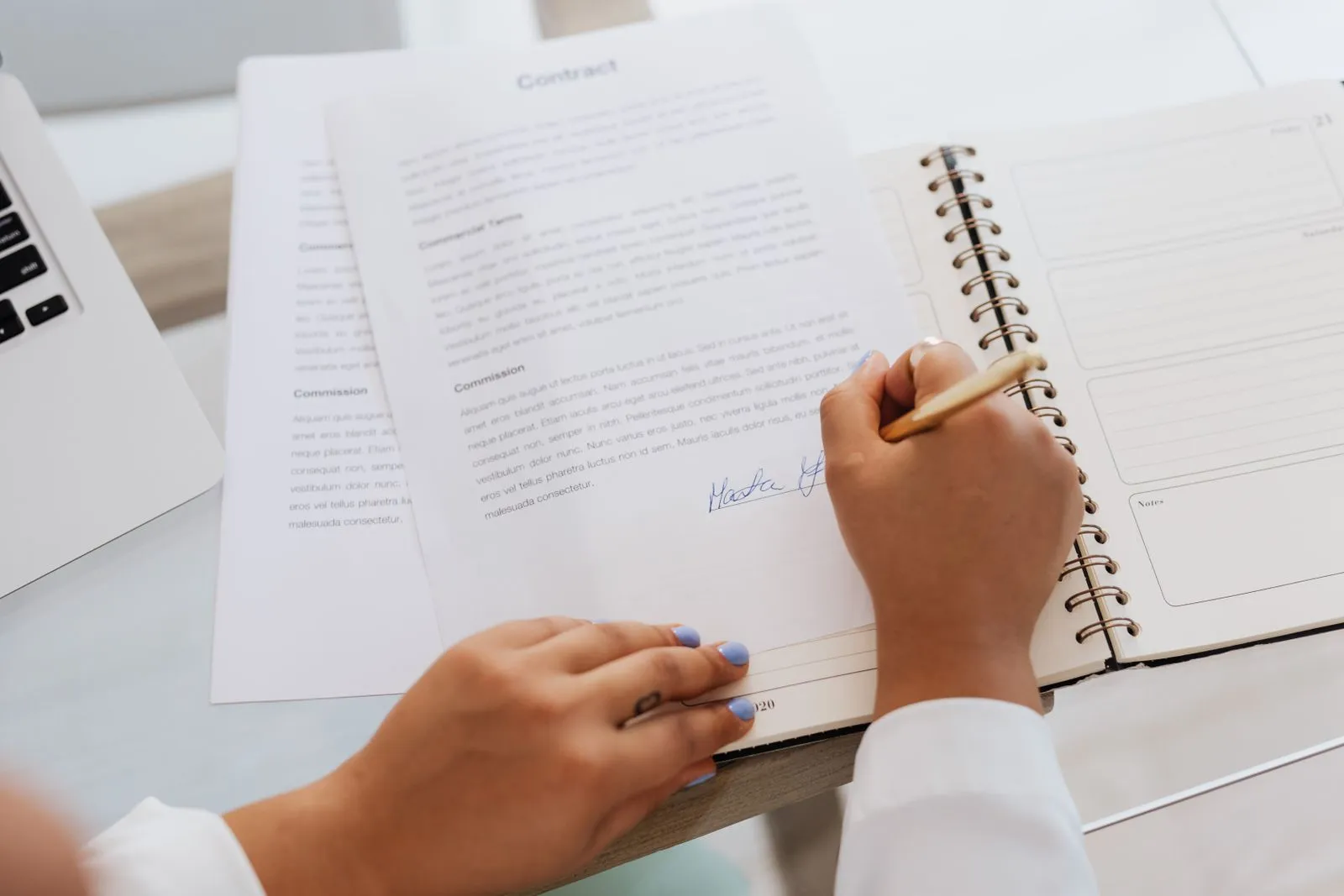 Una mano che firma un contratto